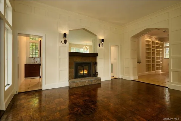 a view of a livingroom with wooden floor and a fireplace