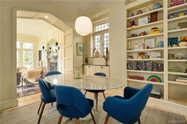 a view of a livingroom with furniture and a book shelf
