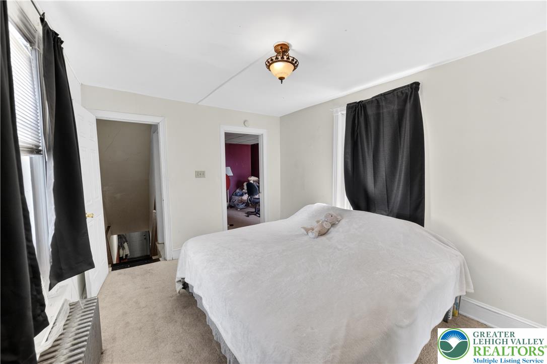 308 State Street Bethlehem, PA 18015 - Photo 22 of 30 a bedroom with a bed and a chandelier