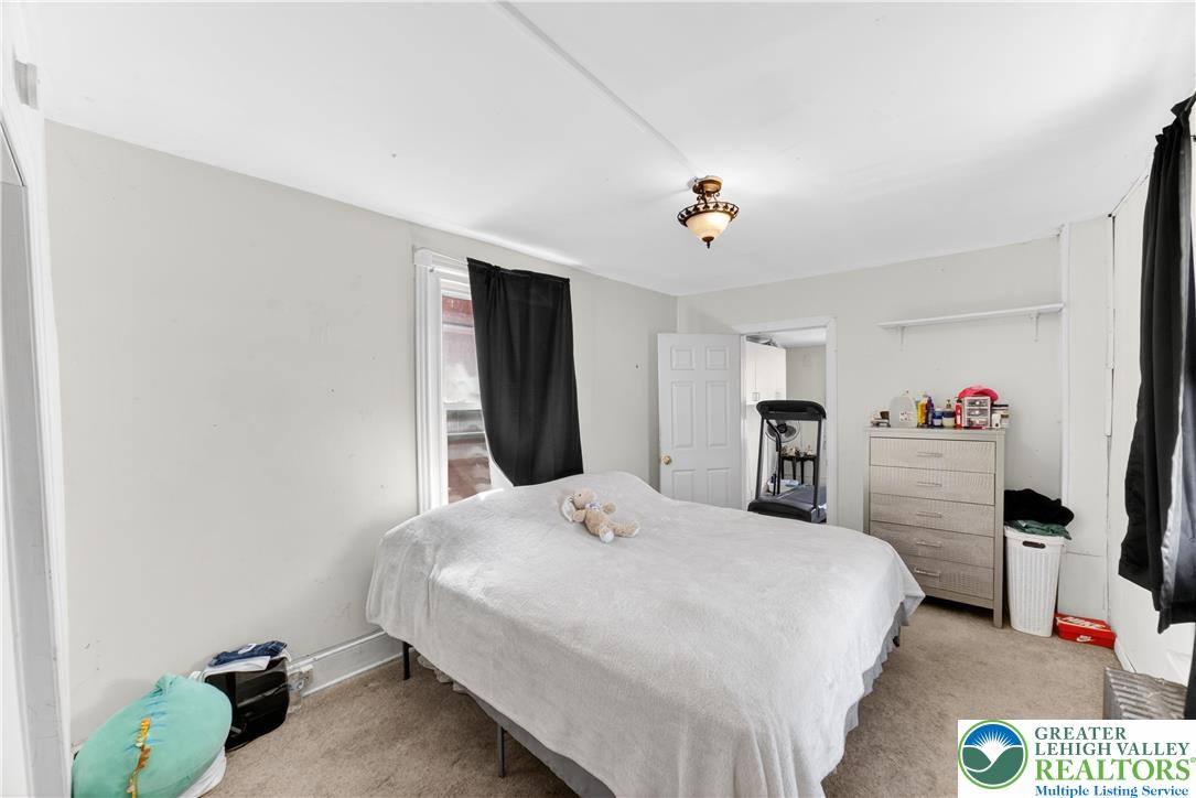 308 State Street Bethlehem, PA 18015 - Photo 23 of 30 a bedroom with a bed and a chandelier