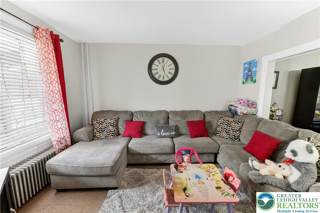 308 State Street Bethlehem, PA 18015 - Photo 10 of 30 a living room with furniture a clock on wall and a window