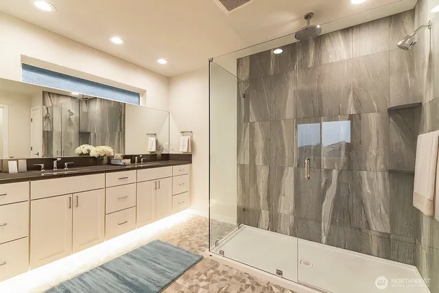 a bathroom with a shower and a sink