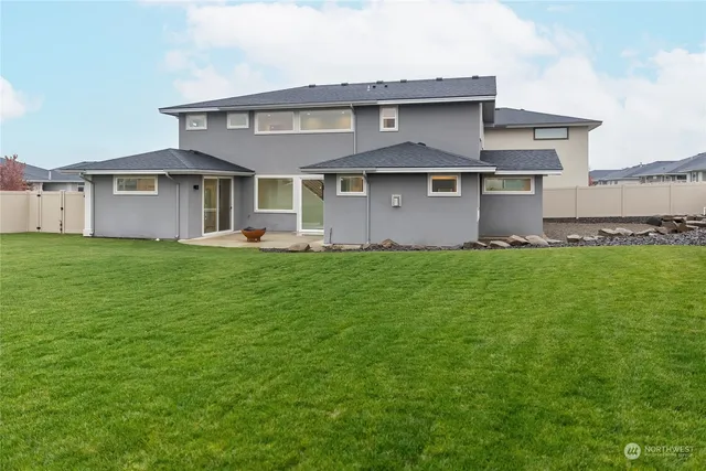a view of a patio with table and chairs potted plants and floor to ceiling window