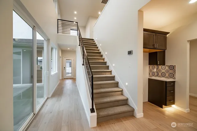 a view of a workspace with furniture and a book shelf