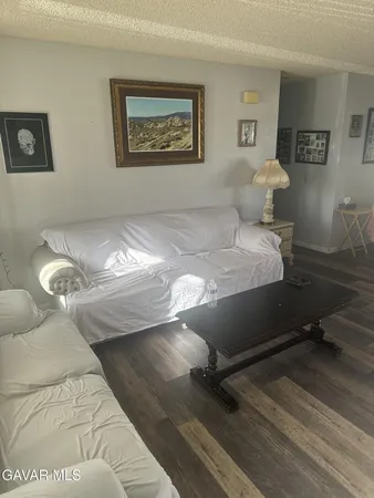 a bed room with a bed and painting on the wall