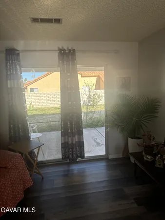 a room with wooden floor and a window