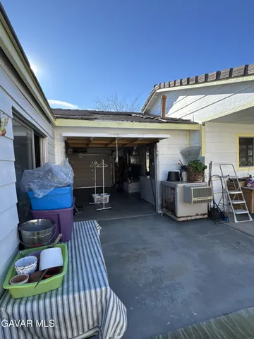 a view of a chairs and table in the patio