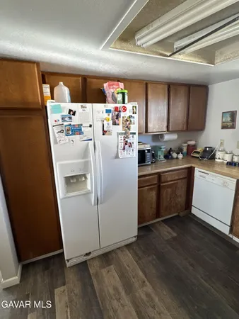 a utility room with refrigerator a stove a sink and a window