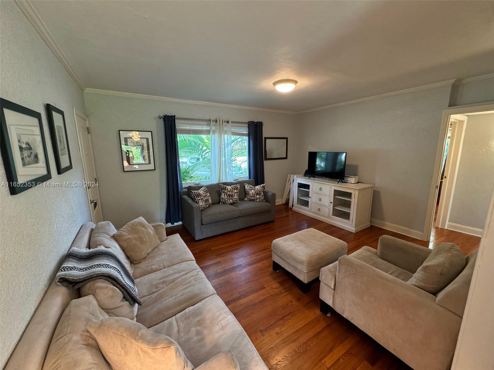 5530 Southwest 76th Street, Unit A Miami, FL 33143 - Photo 3 of 10 a living room with furniture ceiling fan and a window