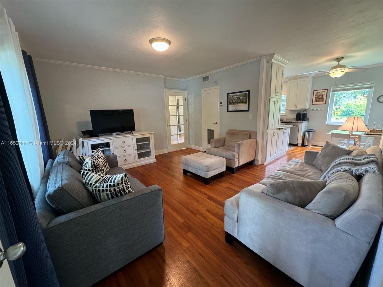 5530 Southwest 76th Street, Unit A Miami, FL 33143 - Photo 4 of 10 a living room with furniture and a flat screen tv