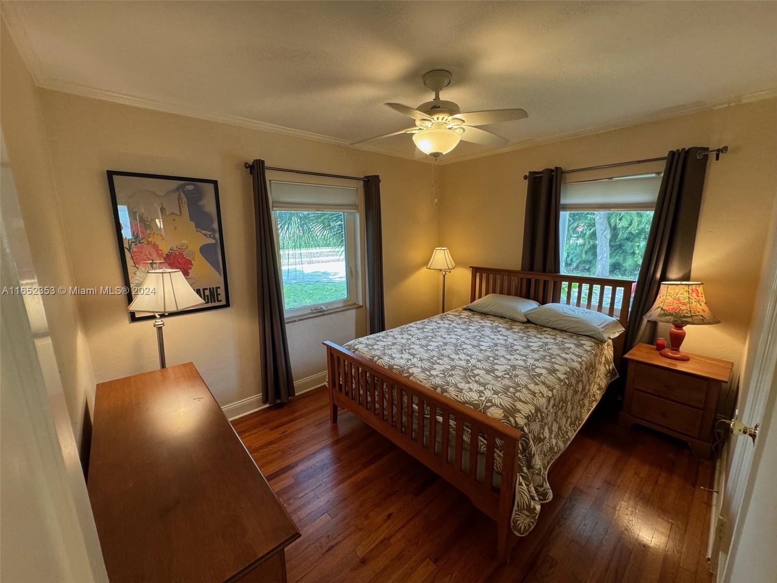 5530 Southwest 76th Street, Unit A Miami, FL 33143 - Photo 5 of 10 a bedroom with a bed and wooden floor