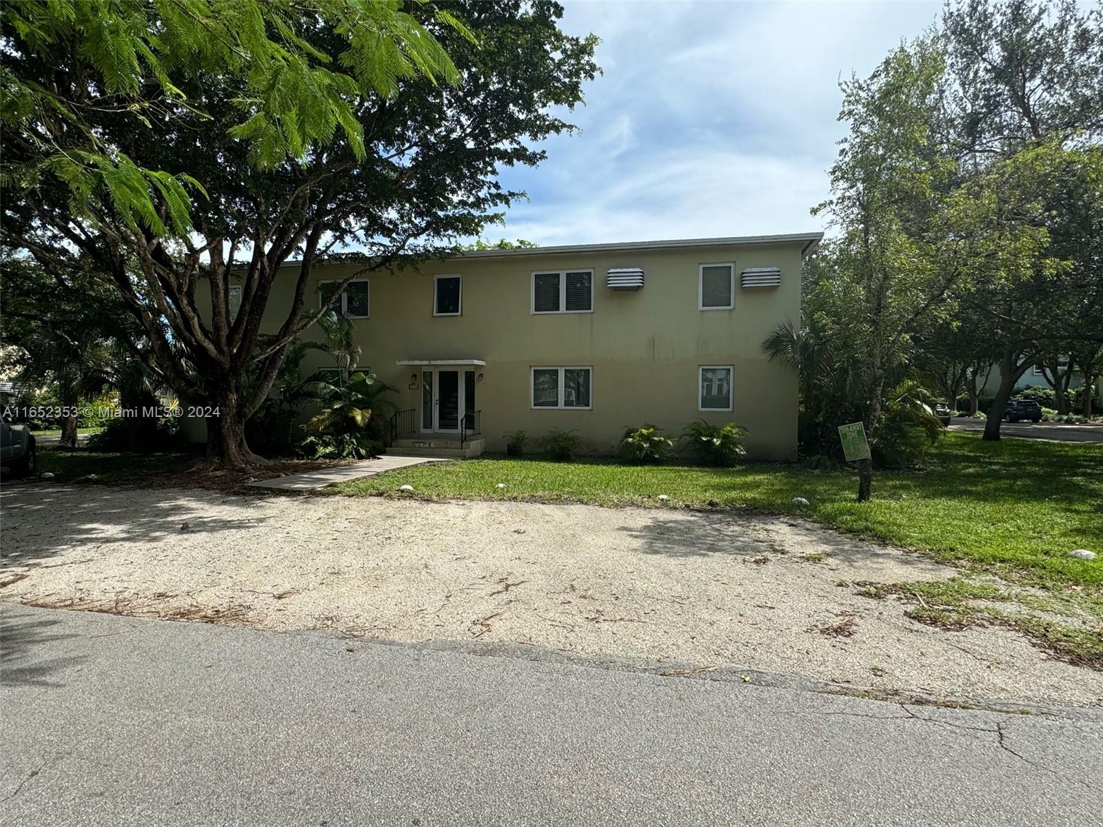 5530 Southwest 76th Street, Unit A Miami, FL 33143 - Photo 10 of 10 a front view of a house with a yard and garage