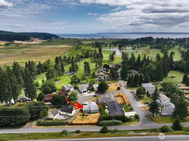 a front view of a house with a yard and outdoor seating