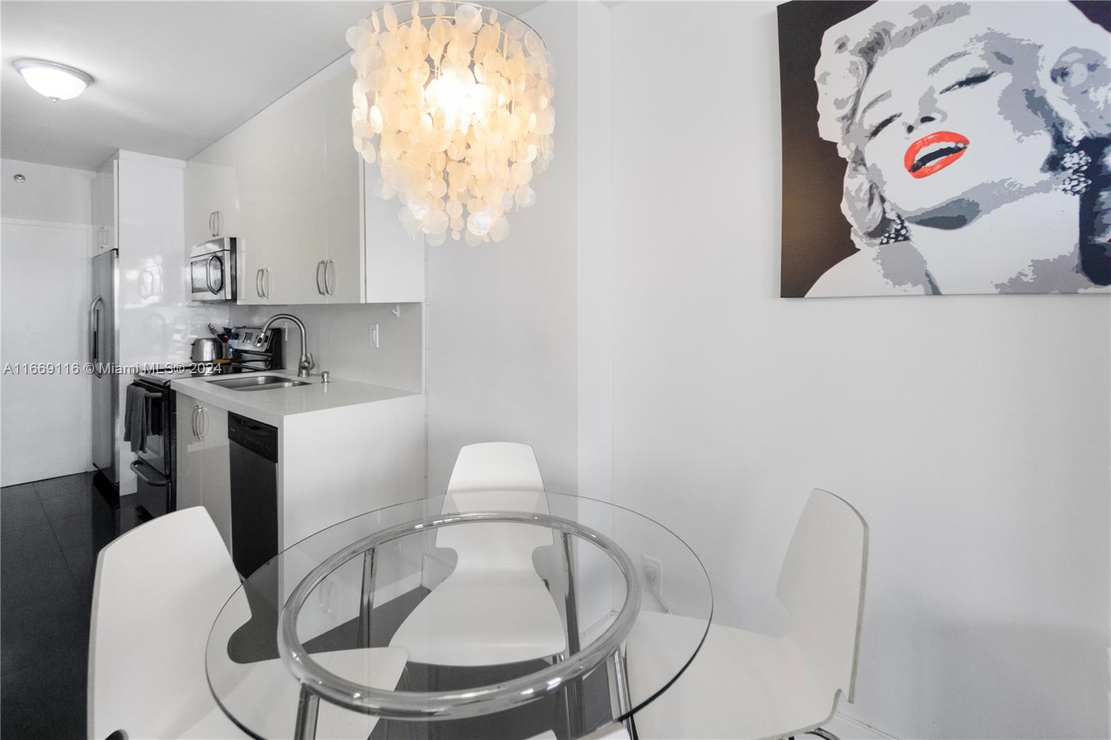 100 Lincoln Road, Unit 1418 Miami Beach, FL 33139 - Photo 1 of 18 a kitchen with a white cabinets a stove and a sink