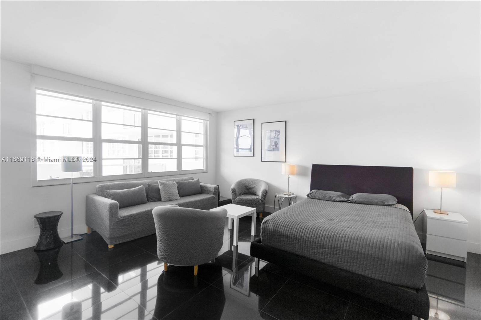 100 Lincoln Road, Unit 1418 Miami Beach, FL 33139 - Photo 4 of 18 a bedroom with two beds and a large window