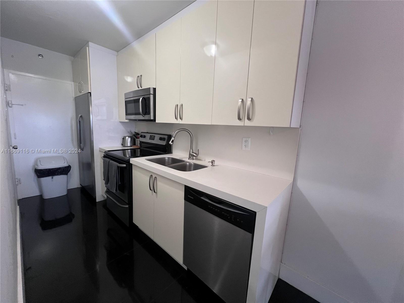 100 Lincoln Road, Unit 1418 Miami Beach, FL 33139 - Photo 5 of 18 a kitchen with stainless steel appliances a stove microwave and refrigerator
