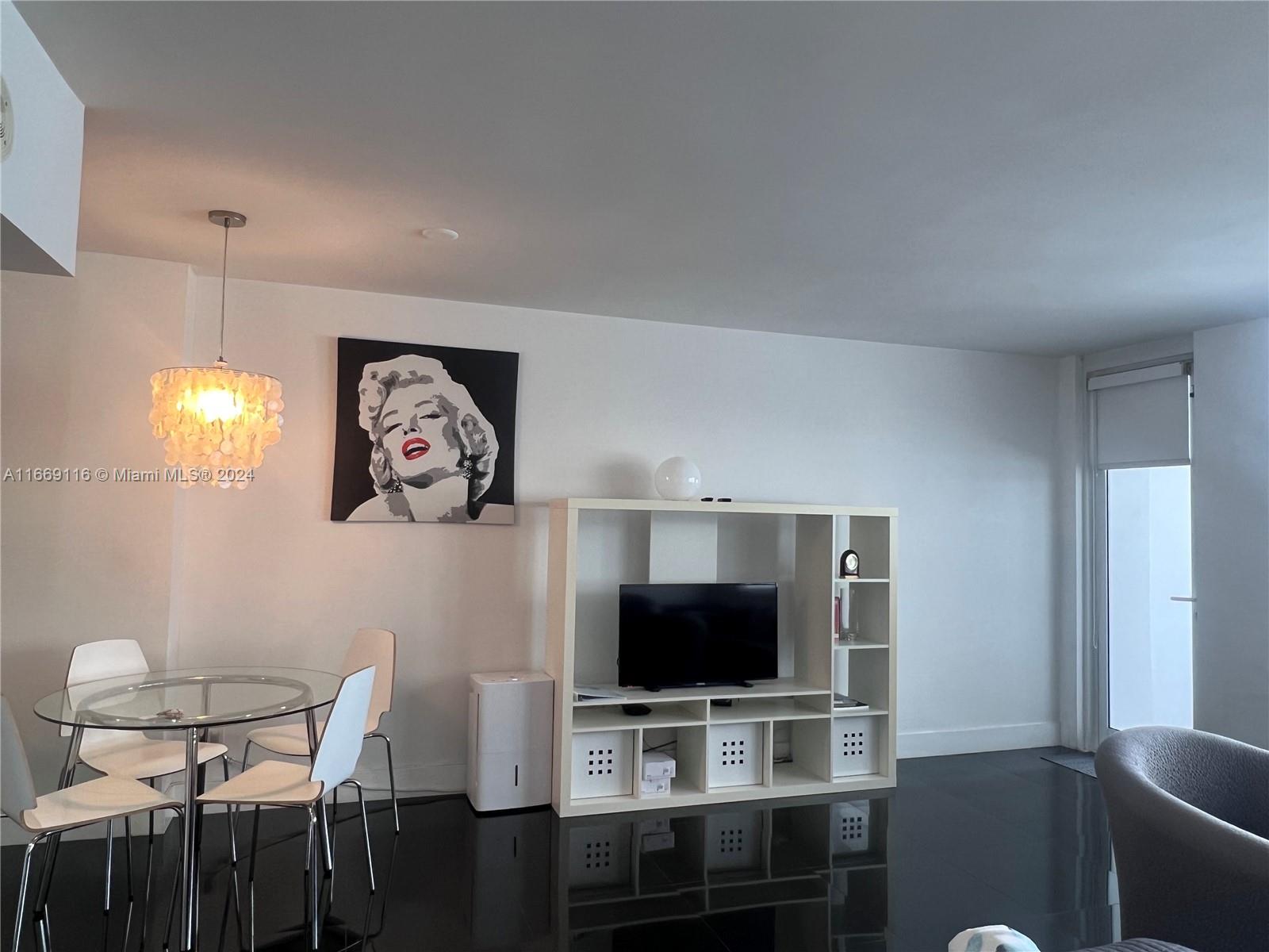 100 Lincoln Road, Unit 1418 Miami Beach, FL 33139 - Photo 6 of 18 a view of a livingroom with furniture and a flat screen tv