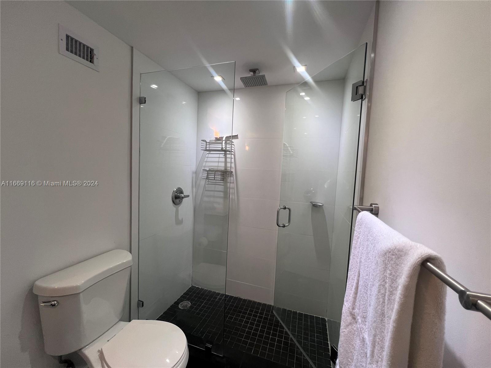 100 Lincoln Road, Unit 1418 Miami Beach, FL 33139 - Photo 8 of 18 a bathroom with a toilet and a shower