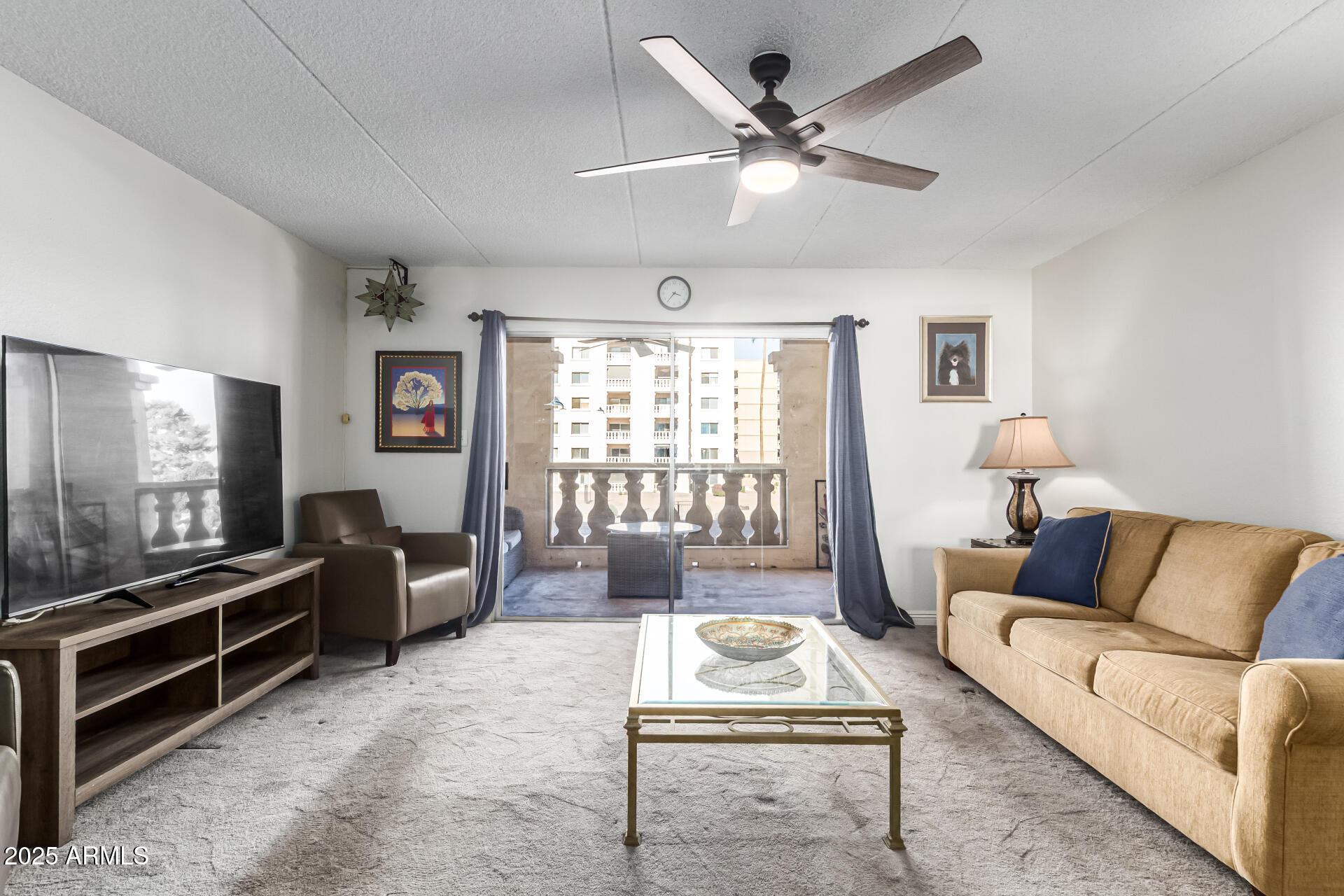 7910 East Camelback Road, Unit 203 Scottsdale, AZ 85251 - Photo 2 of 12 a living room with furniture and a flat screen tv