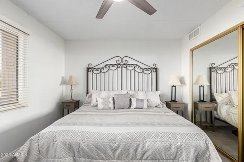 a bedroom with a bed and a window