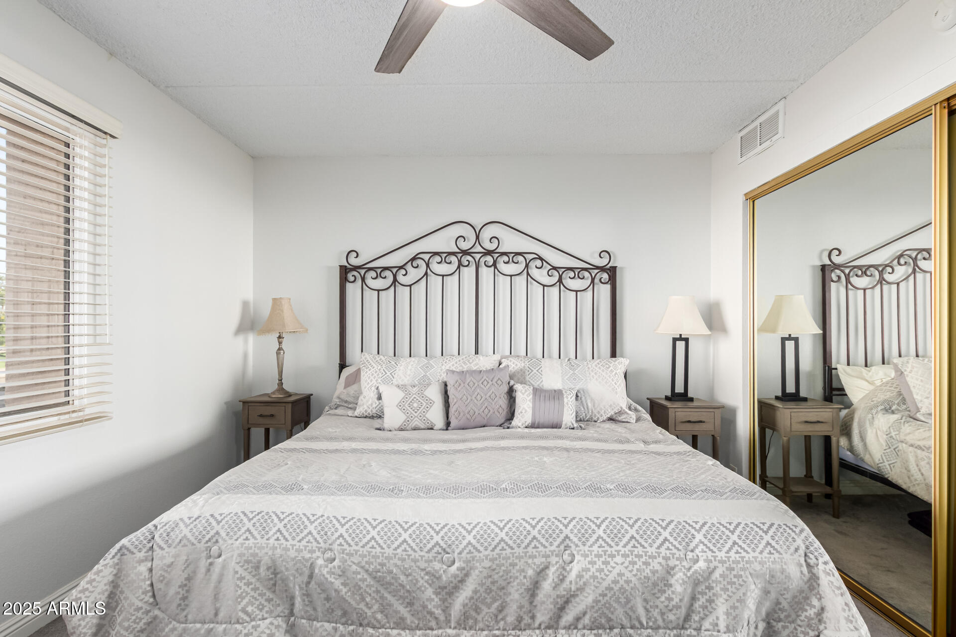 7910 East Camelback Road, Unit 203 Scottsdale, AZ 85251 - Photo 4 of 12 a bedroom with a bed and a window