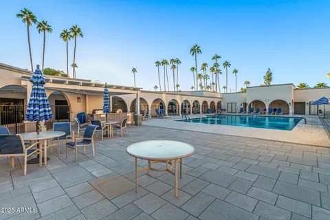a swimming pool with outdoor seating and yard