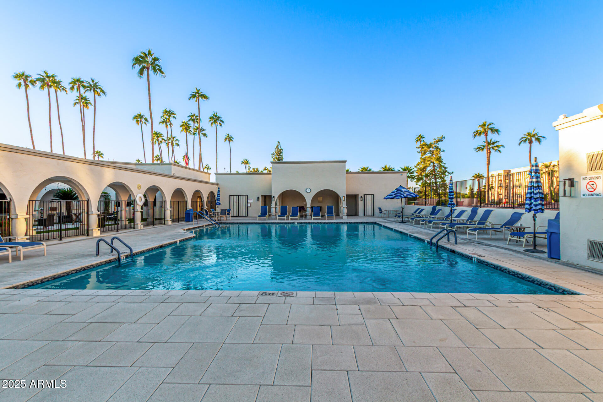 7910 East Camelback Road, Unit 203 Scottsdale, AZ 85251 - Photo 10 of 12 an view of a swimming pool with a lounge chair and a swimming pool