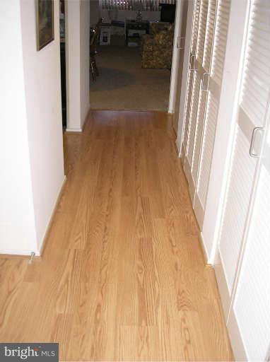 1951 Sagewood Lane, Unit 421 Reston, VA 20191 - Photo 7 of 22 Wood flooring in hallway leads to Master bedroom