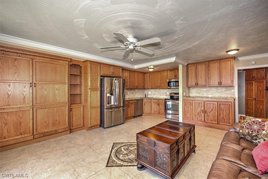 828 Wiggins Pass Road, Unit 10 Naples, FL 34110 - Photo 11 of 17 a kitchen with granite countertop a refrigerator a sink and white cabinets