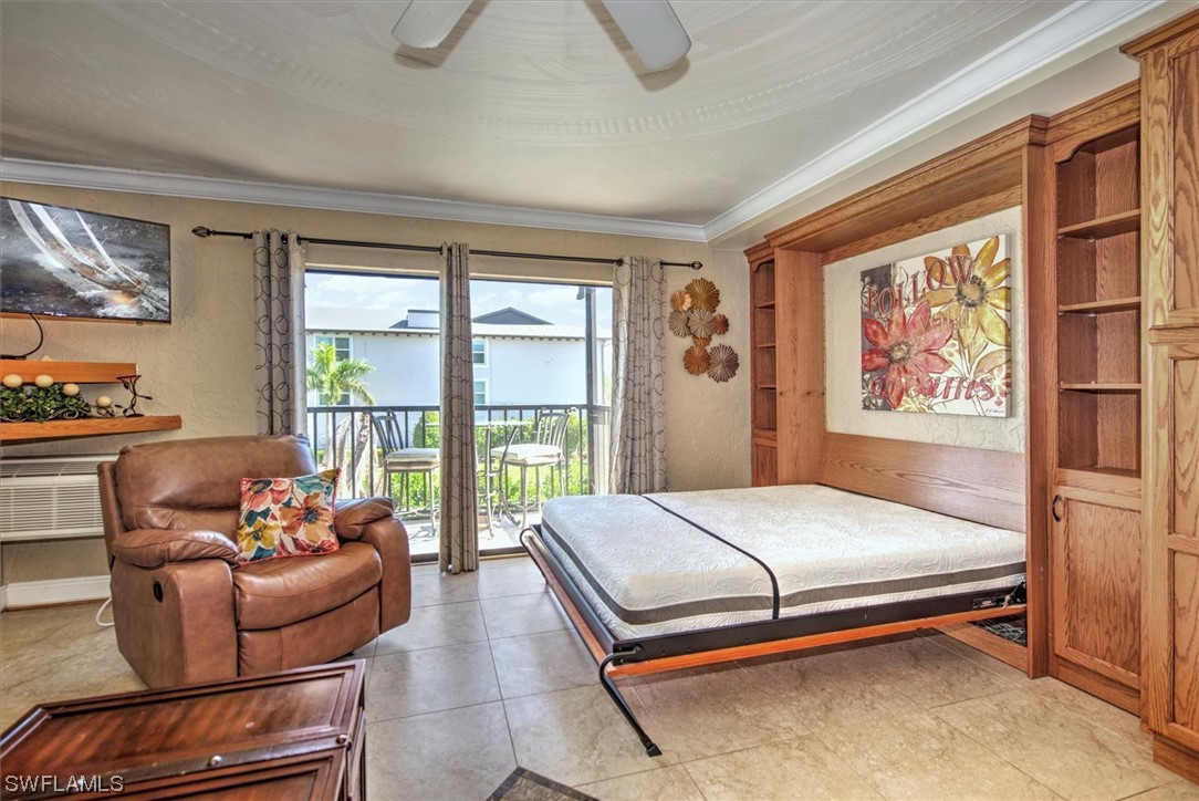 828 Wiggins Pass Road, Unit 10 Naples, FL 34110 - Photo 12 of 17 a bedroom with a bed and glass window
