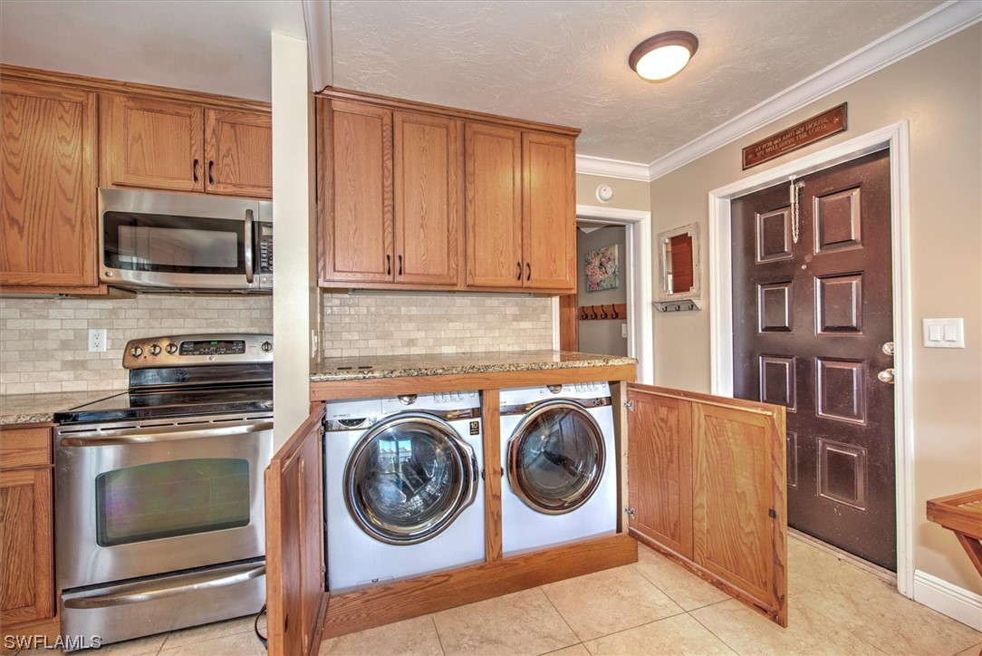 828 Wiggins Pass Road, Unit 10 Naples, FL 34110 - Photo 13 of 17 a utility room with sink dryer and washer
