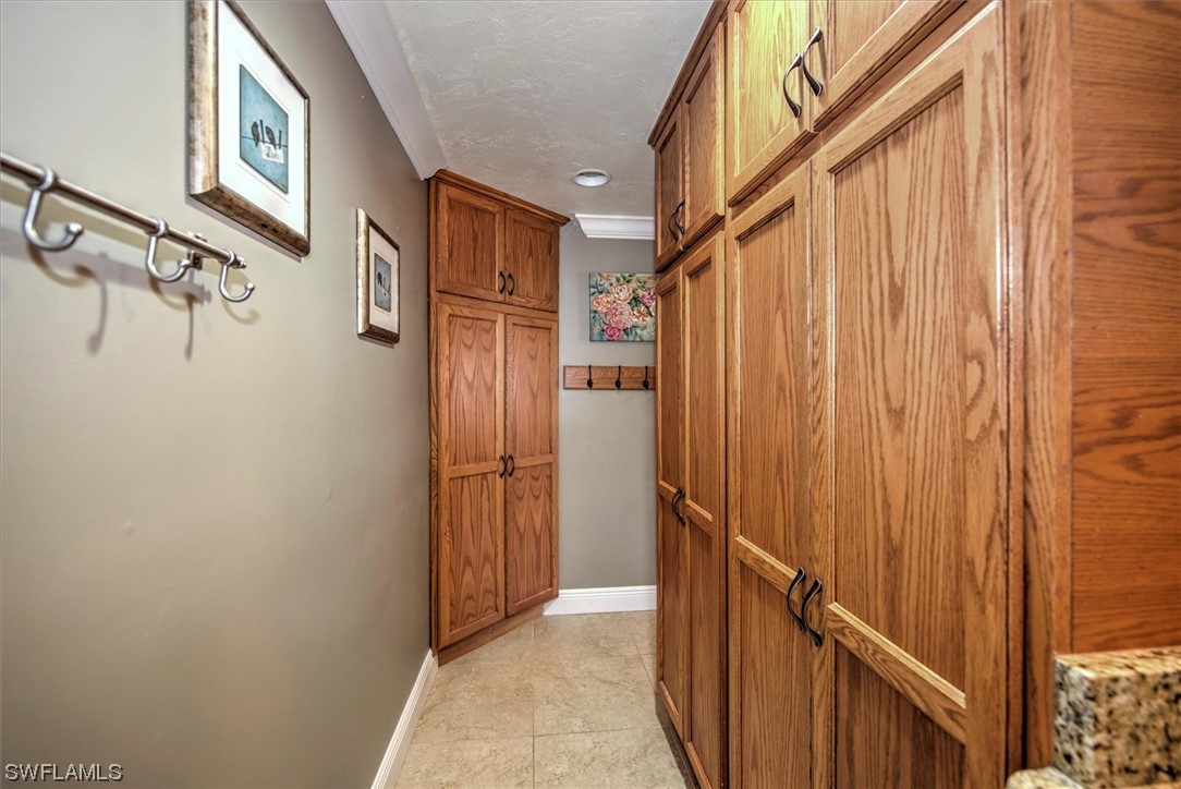 828 Wiggins Pass Road, Unit 10 Naples, FL 34110 - Photo 15 of 17 a view of a hallway with a white walls and stairs