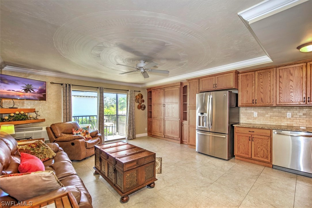 828 Wiggins Pass Road, Unit 10 Naples, FL 34110 - Photo 4 of 17 a living room with furniture windows and a refrigerator
