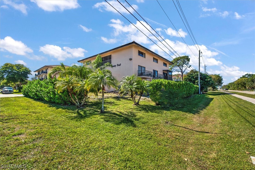 828 Wiggins Pass Road, Unit 10 Naples, FL 34110 - Photo 5 of 17 a backyard of a house with lots of green space