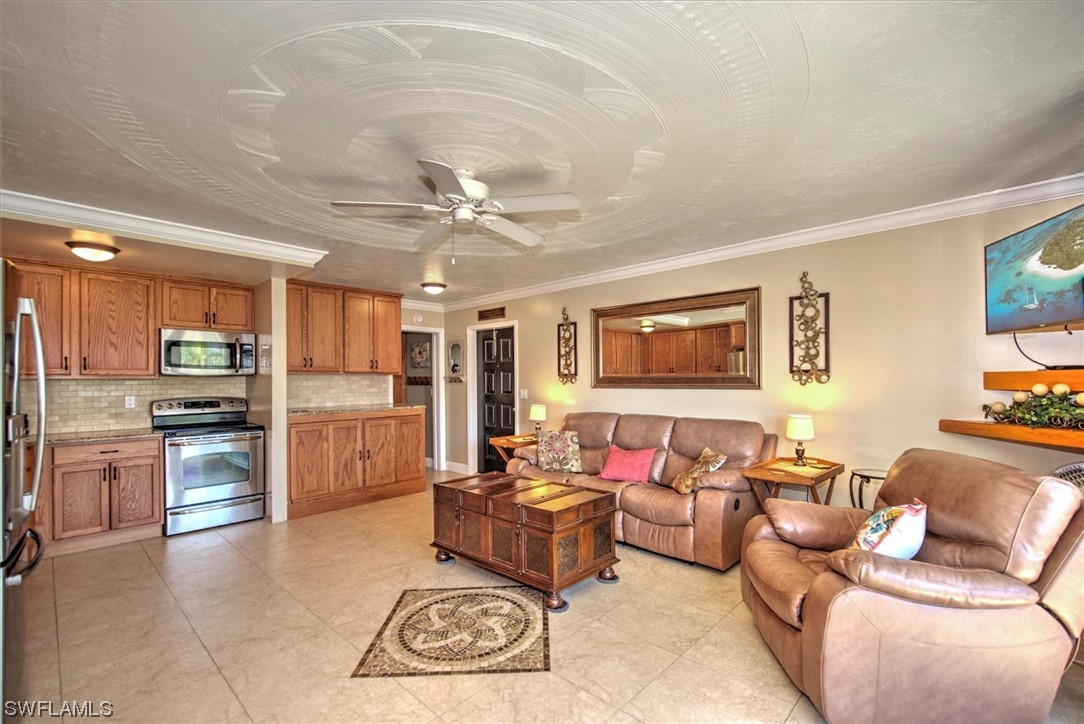 828 Wiggins Pass Road, Unit 10 Naples, FL 34110 - Photo 8 of 17 a living room with furniture and kitchen view