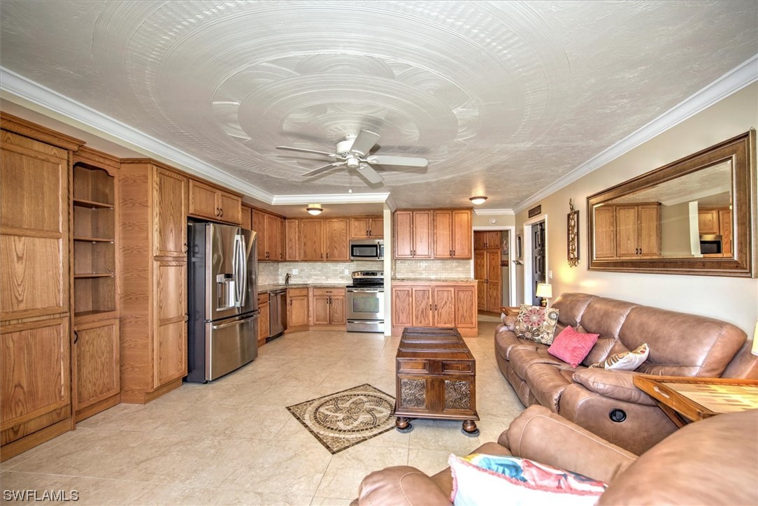 828 Wiggins Pass Road, Unit 10 Naples, FL 34110 - Photo 10 of 17 a living room with furniture kitchen view and a refrigerator