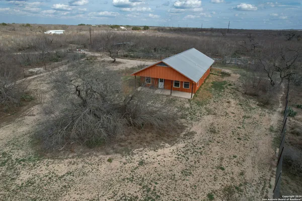 an aerial view of a house with a yard