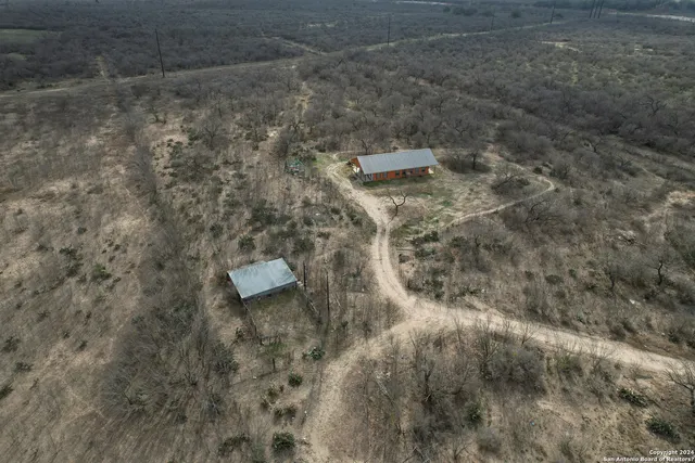 a aerial view of a house with a yard