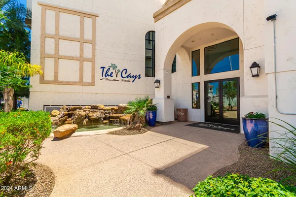 a building with potted plants in front of door