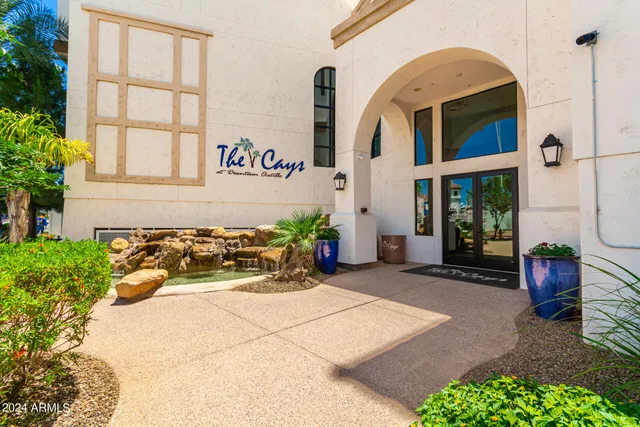 a building with potted plants in front of door