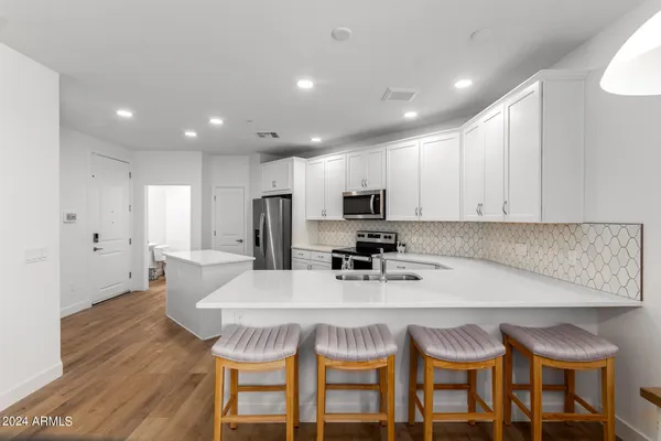 a kitchen with a sink stove and microwave