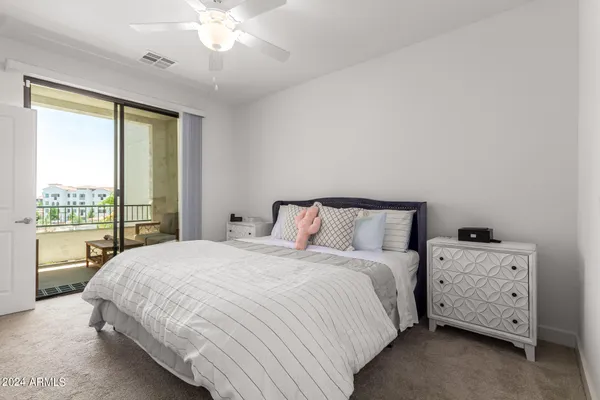a bedroom with a bed and a night stand