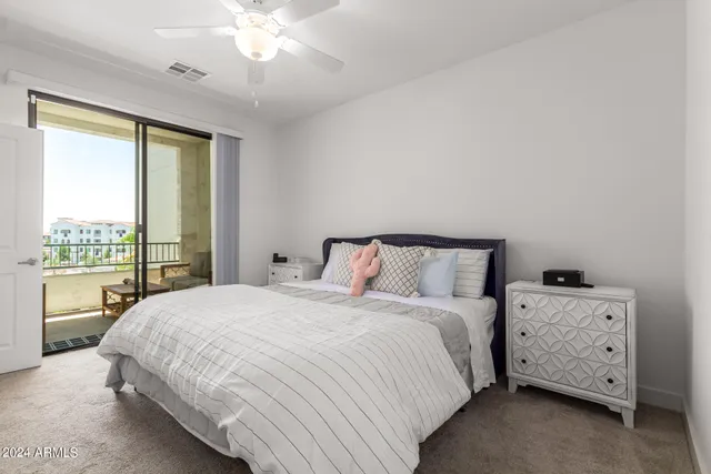 a bedroom with a bed and a night stand