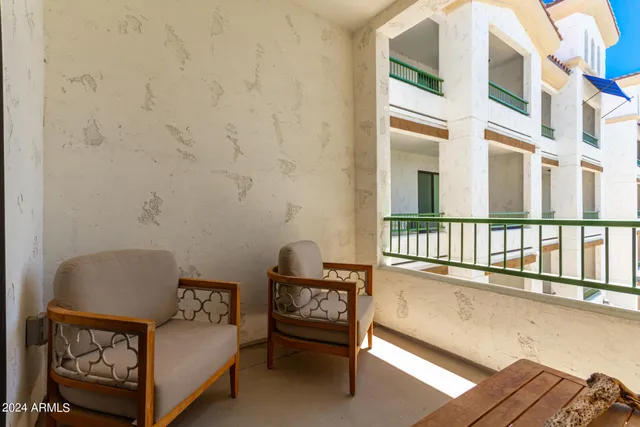 a living room with furniture a fireplace and wooden floor