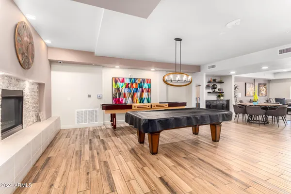 a room with stainless steel appliances kitchen island a table and chairs in it