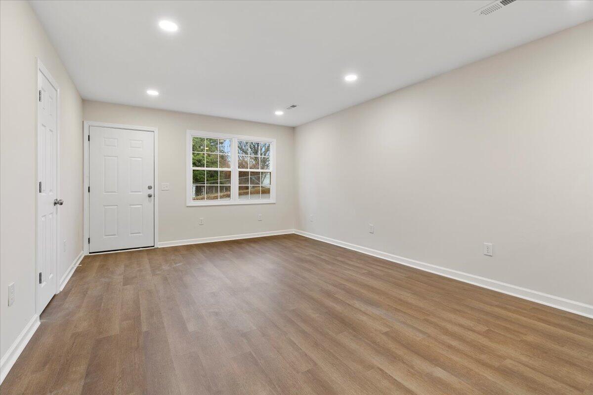 127 State Pulaski, VA 24301 - Photo 6 of 35 an empty room with wooden floor and windows