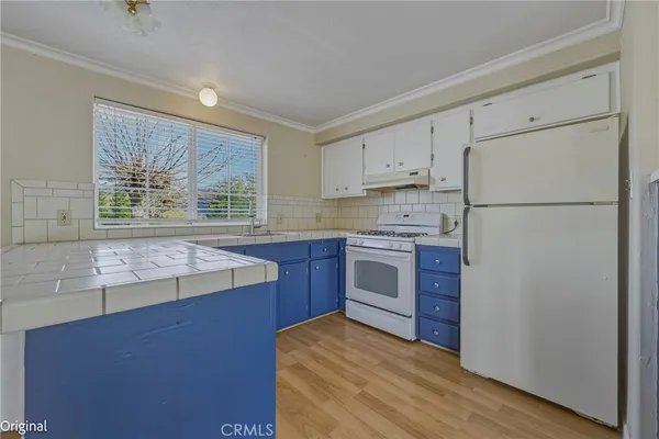 a kitchen with a stove a refrigerator and a sink