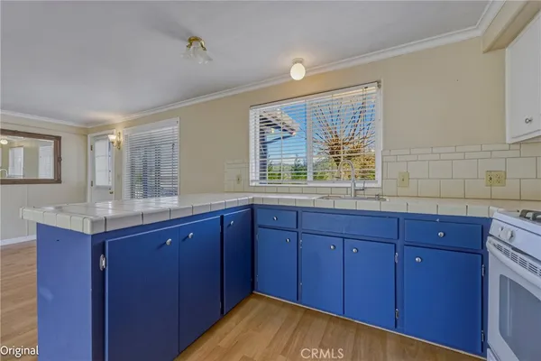 a kitchen with stainless steel appliances granite countertop wooden cabinets and sink