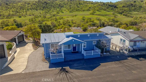 an aerial view of a house with a yard