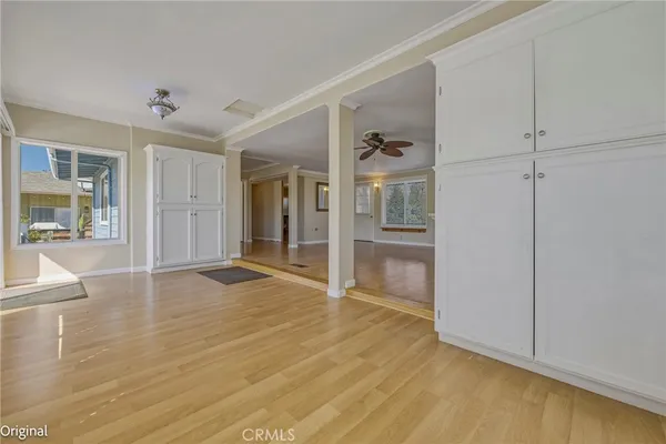 wooden floor in an empty room with a window